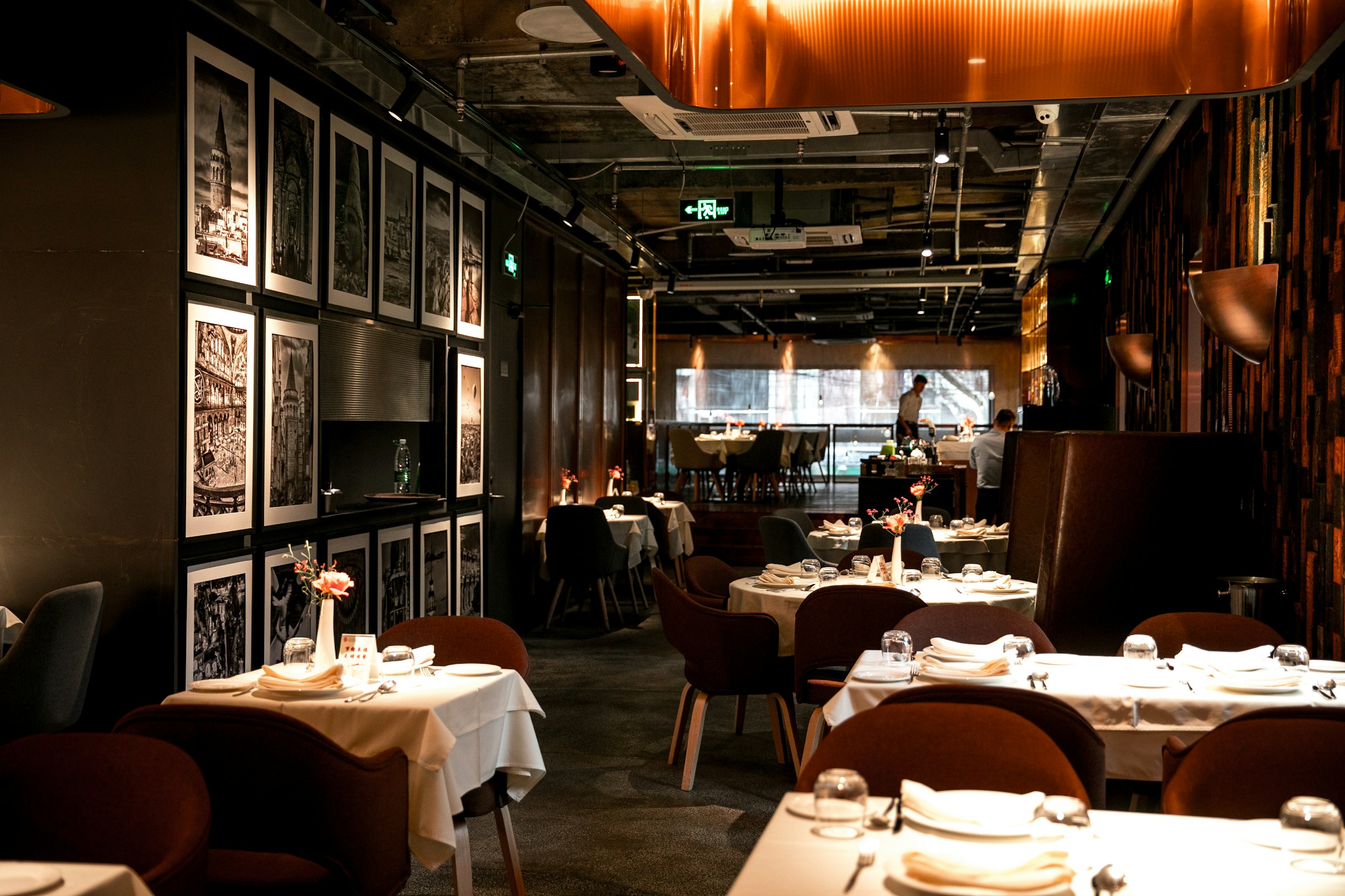 Interior of an elegant restaurant with framed artwork on the walls